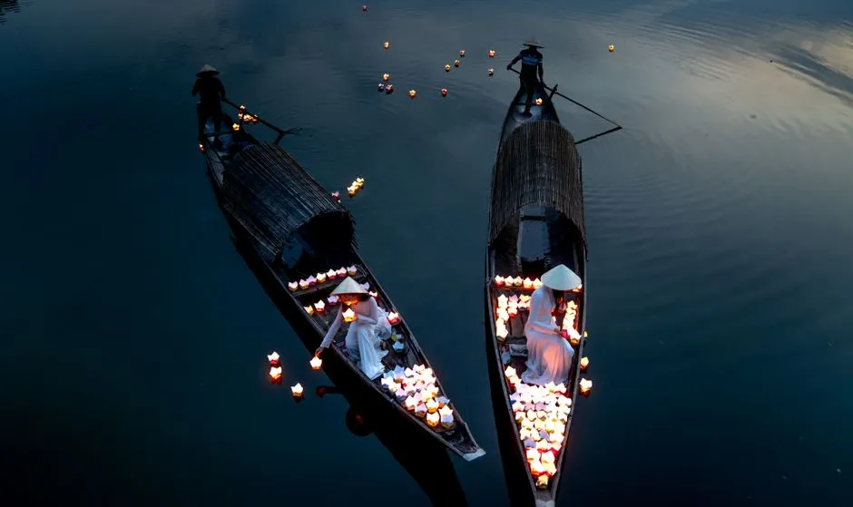 Peaceful scene of lantern-filled boats on a river at Hoi An Lantern Festival." loading="eager" fetchpriority="high