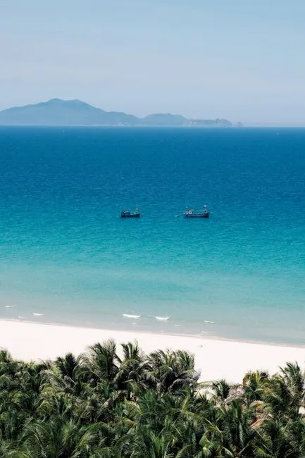 Breathtaking view of Cam Ranh's turquoise waters, sandy beach, and distant islands, perfect for a tropical getaway." loading="eager" fetchpriority="high